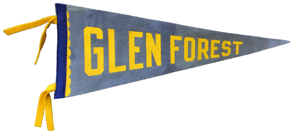 Glen Forest commemorative pennant given to students between 1964 and 1970. This particular pennant is faded blue with Glen Forest written in gold lettering. It was given as a gift to the school by former student Sue Ann Hilten who attended Glen Forest in the 1960s. 